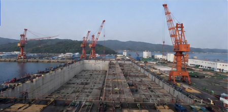 Large shipyard facility with cranes and dry dock